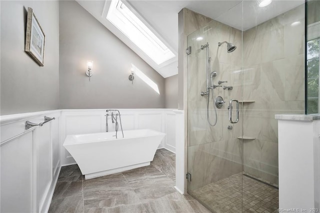 26 Ruscoe Rd, Wilton, CT 06897 - bathroom with a skylight, a decorative wall, a freestanding bath, a shower stall, and marble finish floors
