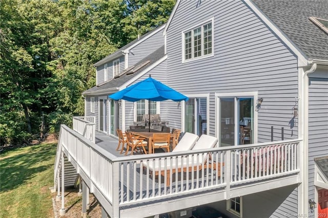 26 Ruscoe Rd, Wilton, CT 06897 - back of house featuring a shingled roof, a wooden deck, outdoor dining space, and a lawn