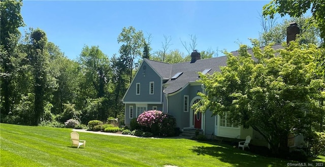 26 Ruscoe Rd, Wilton, CT 06897 - view of property exterior featuring a lawn, a chimney, and entry steps