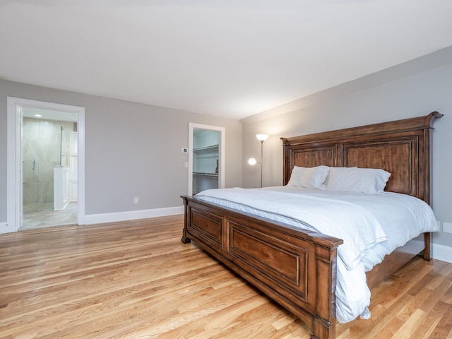 26 Ruscoe Rd, Wilton, CT 06897 - bedroom with light wood finished floors, a walk in closet, ensuite bath, and a closet