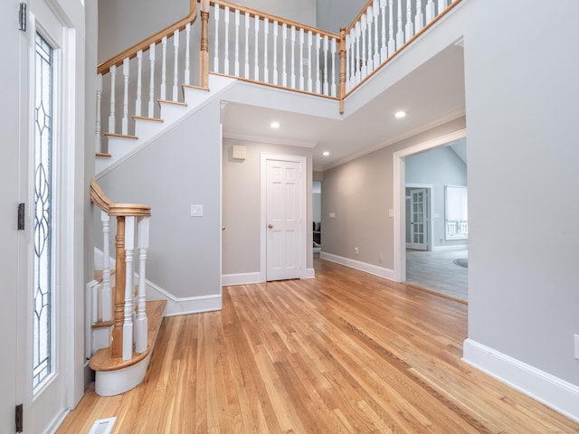 26 Ruscoe Rd, Wilton, CT 06897 - entryway with hardwood / wood-style floors, crown molding, stairway, healthy amount of natural light, and recessed lighting