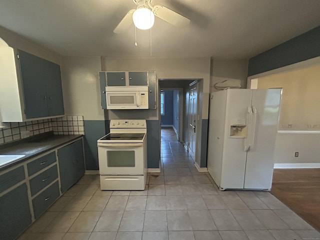 58 Eggleston St, Torrington, CT 06790 - kitchen featuring white appliances, light tile patterned floors, dark countertops, ceiling fan, and tasteful backsplash