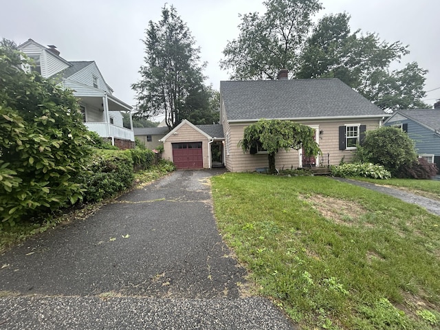 58 Eggleston St, Torrington, CT 06790 - view of front facade featuring driveway, a garage, an outdoor structure, a front yard, and a chimney