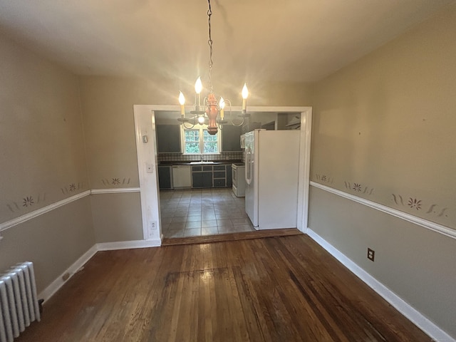 58 Eggleston St, Torrington, CT 06790 - unfurnished dining area with radiator heating unit, a chandelier, and wood finished floors
