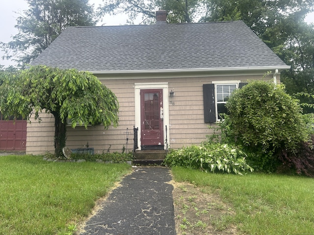 58 Eggleston St, Torrington, CT 06790 - view of front of home featuring a shingled roof and a chimney