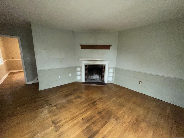 58 Eggleston St, Torrington, CT 06790 - unfurnished living room featuring wood finished floors and a brick fireplace