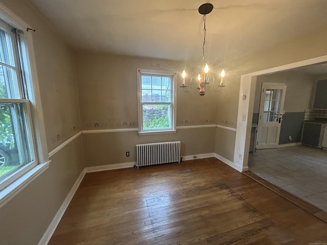 58 Eggleston St, Torrington, CT 06790 - unfurnished dining area with radiator heating unit, a chandelier, and wood finished floors