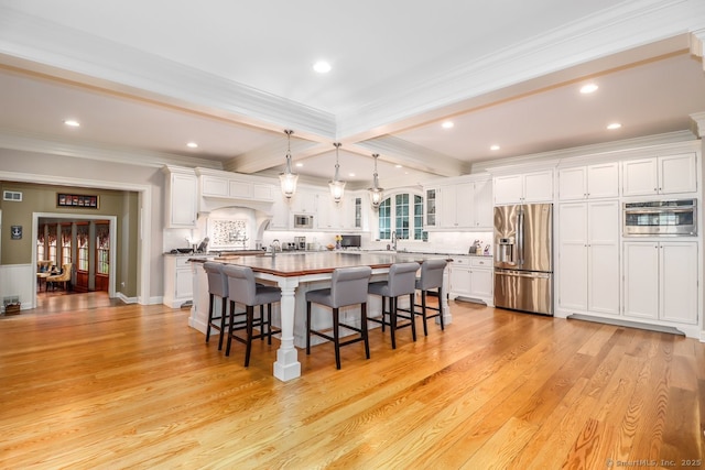 kitchen with stainless steel refrigerator with ice dispenser, crown molding, beam ceiling, white cabinets, and a breakfast bar