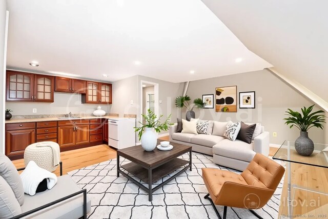 living area with light wood-style flooring and recessed lighting
