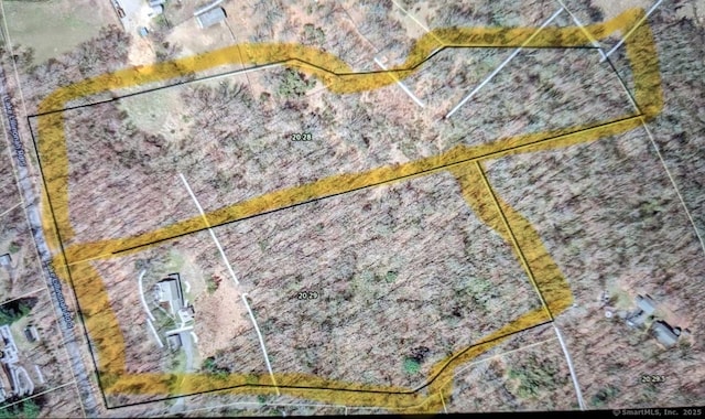aerial view of property and surrounding area featuring property boundaries highlighted