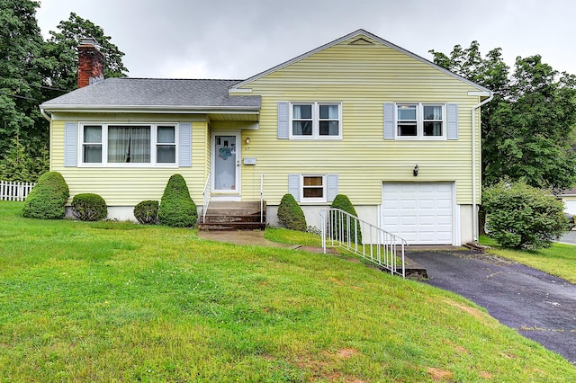 47 Hoffman Rd, Manchester, CT 06042 - tri-level home with an attached garage, driveway, a chimney, and a front yard