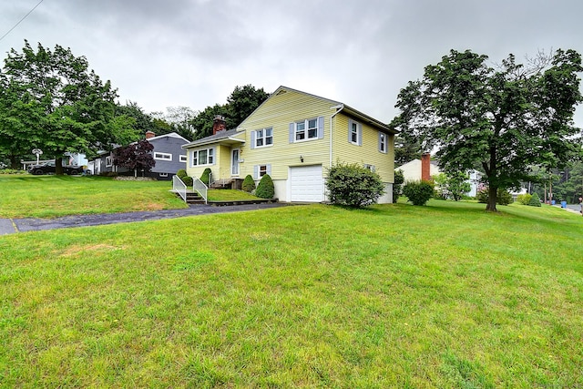 47 Hoffman Rd, Manchester, CT 06042 - tri-level home featuring a garage, a chimney, driveway, and a front lawn