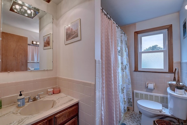 47 Hoffman Rd, Manchester, CT 06042 - bathroom featuring tile walls, radiator heating unit, vanity, wainscoting, and a shower with shower curtain