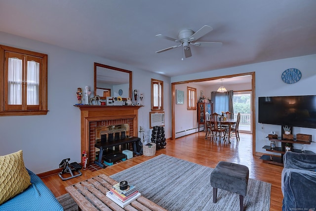 47 Hoffman Rd, Manchester, CT 06042 - living room featuring a baseboard heating unit, ceiling fan, wood finished floors, and a brick fireplace