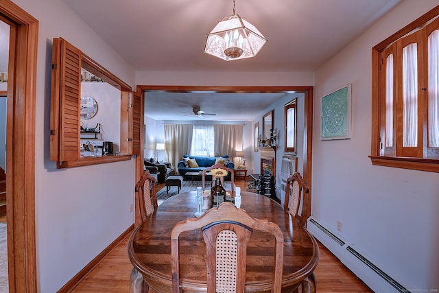 47 Hoffman Rd, Manchester, CT 06042 - dining area featuring a baseboard heating unit, light wood finished floors, a fireplace, and ceiling fan