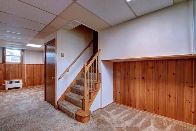 47 Hoffman Rd, Manchester, CT 06042 - stairway with a paneled ceiling, carpet, wooden walls, radiator heating unit, and wainscoting