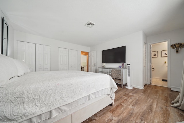7 Derbyshire Unit 7, Derby, CT 06418 - bedroom featuring wood finished floors, two closets, and ensuite bathroom