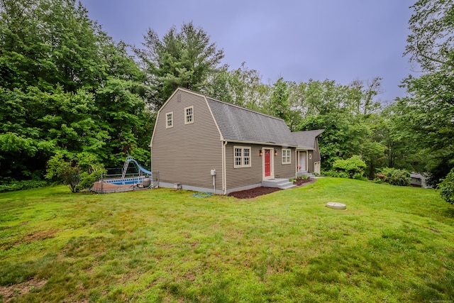 34 Roberts Rd, Marlborough, CT 06447 - back of house featuring an outdoor pool, a lawn, and roof with shingles