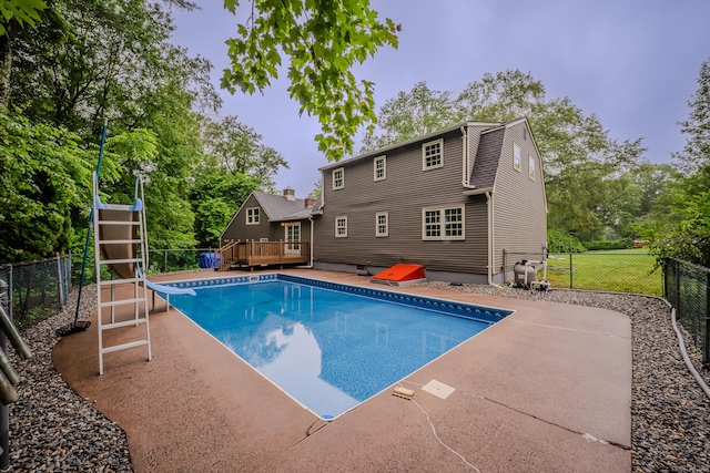 34 Roberts Rd, Marlborough, CT 06447 - view of pool featuring a wooden deck, a water slide, a patio area, and view of wooded area