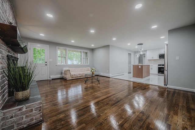 34 Roberts Rd, Marlborough, CT 06447 - living room with a brick fireplace, wood finished floors, recessed lighting, and baseboard heating