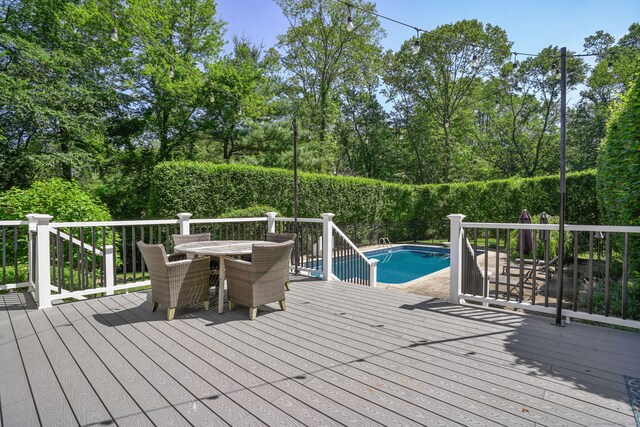 112 Greenbrier Rd, Trumbull, CT 06611 - wooden deck featuring an outdoor pool, outdoor dining area, and view of scattered trees