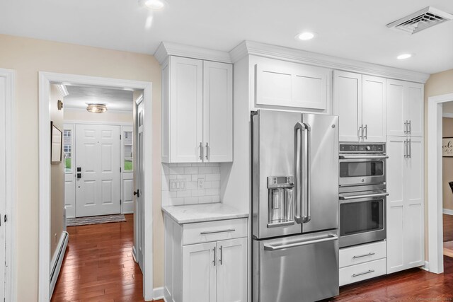 112 Greenbrier Rd, Trumbull, CT 06611 - kitchen featuring stainless steel appliances, baseboard heating, dark wood-style floors, white cabinetry, and recessed lighting