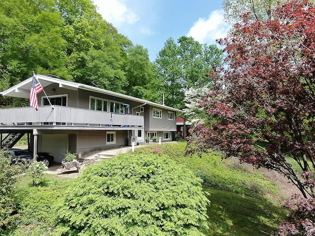 204 W Hill Rd, New Hartford, CT 06057 - back of property with an attached garage, a deck, and stairway