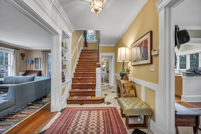 95 Parsons St, Wallingford, CT 06492 - entrance foyer with plenty of natural light, stairs, ornamental molding, and light wood finished floors
