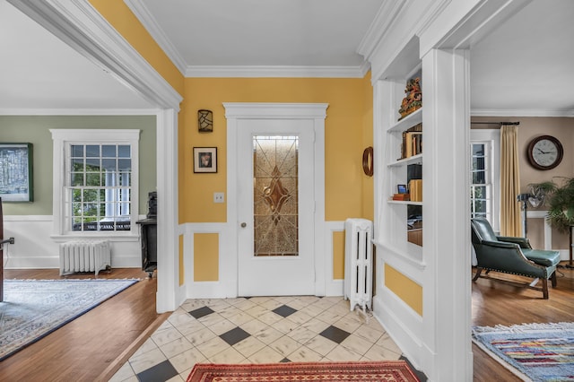 95 Parsons St, Wallingford, CT 06492 - entrance foyer with radiator, crown molding, a wainscoted wall, and light tile patterned flooring
