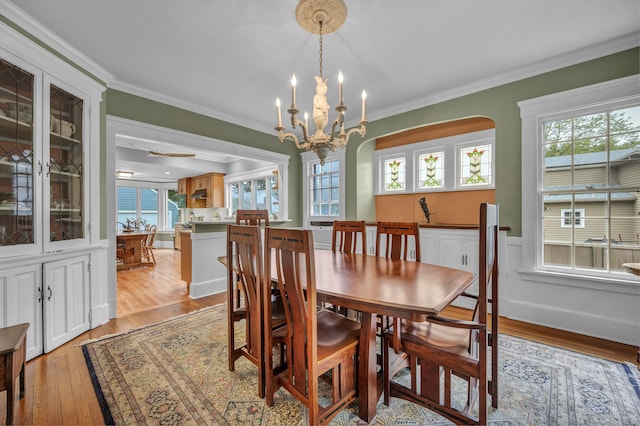 95 Parsons St, Wallingford, CT 06492 - dining room featuring light wood finished floors, ornamental molding, a chandelier, and arched walkways