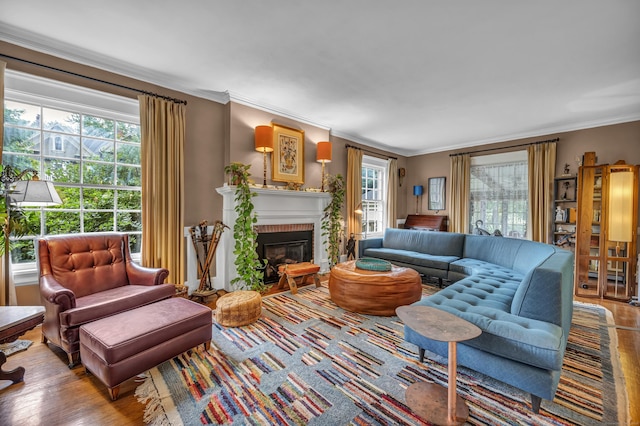 95 Parsons St, Wallingford, CT 06492 - living area featuring healthy amount of natural light, a brick fireplace, crown molding, and wood finished floors
