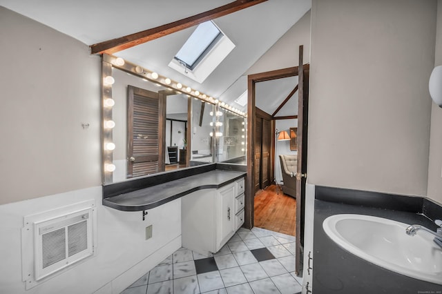 95 Parsons St, Wallingford, CT 06492 - bathroom with a skylight, vanity, and vaulted ceiling