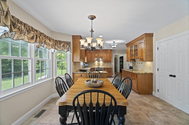 8 Marie Ln, Wallingford, CT 06492 - dining area featuring a chandelier and baseboards