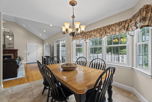 8 Marie Ln, Wallingford, CT 06492 - dining area with healthy amount of natural light, vaulted ceiling, a fireplace, a chandelier, and recessed lighting