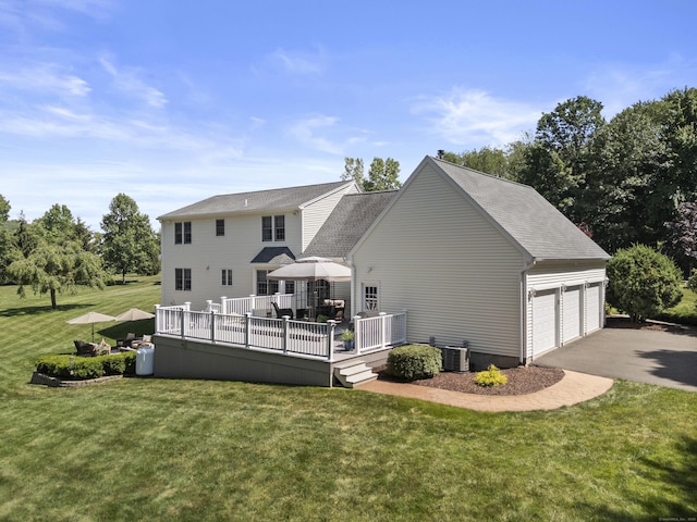 8 Marie Ln, Wallingford, CT 06492 - back of property with a lawn, a garage, a deck, and a shingled roof