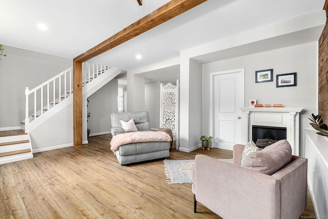 1376 W St, Southington, CT 06489 - living room with stairs, light wood-style flooring, a glass covered fireplace, and recessed lighting