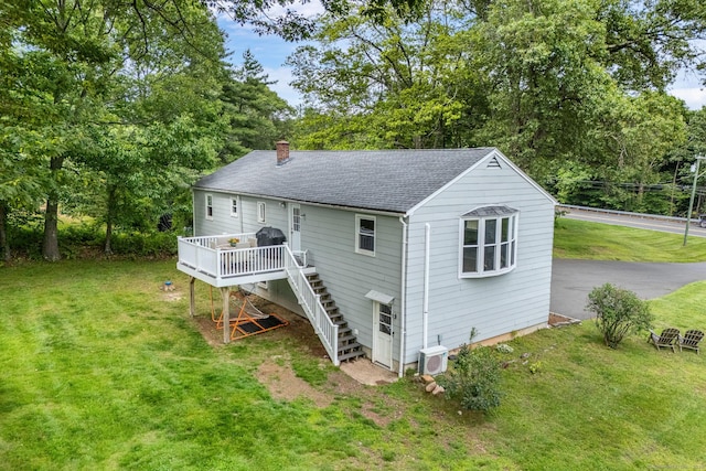 1376 W St, Southington, CT 06489 - rear view of house featuring stairs, a chimney, a wooden deck, roof with shingles, and a lawn