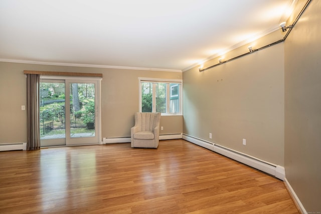 2 Talcott Gln Unit F, Farmington, CT 06032 - unfurnished room with baseboard heating, crown molding, plenty of natural light, and light wood-style floors