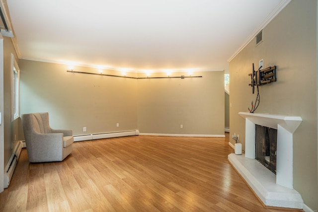 2 Talcott Gln Unit F, Farmington, CT 06032 - unfurnished room with a baseboard radiator, ornamental molding, a fireplace with raised hearth, light wood-style flooring, and baseboard heating