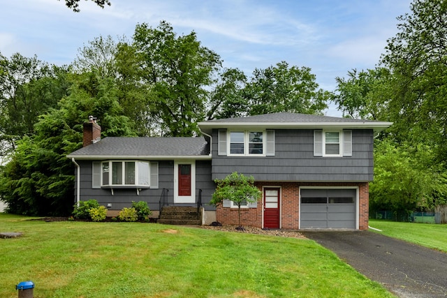 38 Evelyn Rd, Bristol, CT 06010 - tri-level home with an attached garage, asphalt driveway, a chimney, and a front lawn