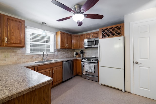 38 Evelyn Rd, Bristol, CT 06010 - kitchen with stainless steel appliances, brown cabinets, decorative backsplash, and light countertops