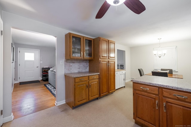 38 Evelyn Rd, Bristol, CT 06010 - kitchen featuring brown cabinetry, glass insert cabinets, light colored carpet, and a ceiling fan