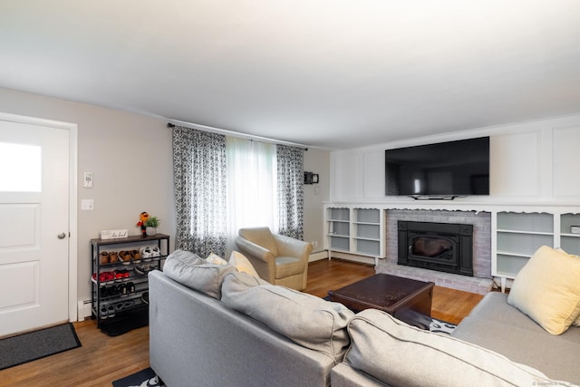 38 Evelyn Rd, Bristol, CT 06010 - living area with wood finished floors, a brick fireplace, and a baseboard heating unit