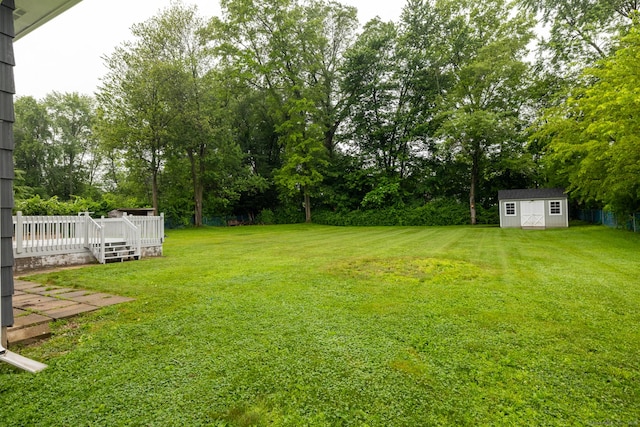 38 Evelyn Rd, Bristol, CT 06010 - view of green lawn with a wooden deck, a shed, and view of wooded area