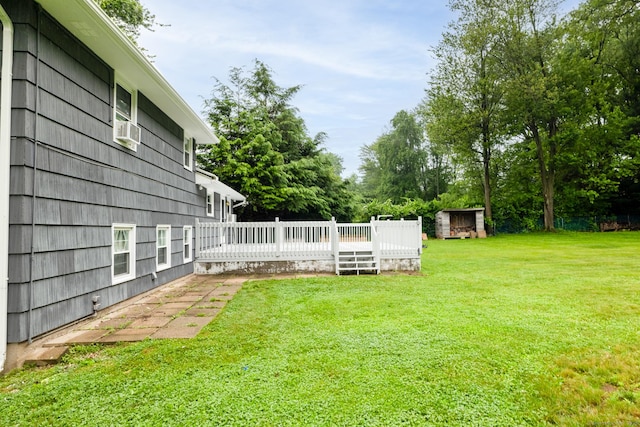 38 Evelyn Rd, Bristol, CT 06010 - view of green lawn with a wooden deck, cooling unit, and a storage unit