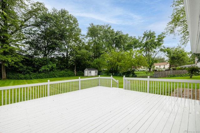 38 Evelyn Rd, Bristol, CT 06010 - wooden deck with a storage unit, a lawn, and view of scattered trees