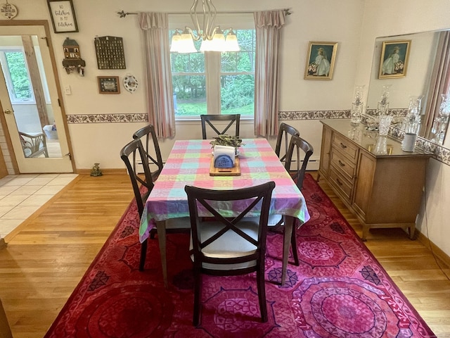 39 Mariner Cir, Trumbull, CT 06611 - dining space with light wood finished floors, a baseboard radiator, and a chandelier