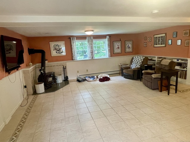39 Mariner Cir, Trumbull, CT 06611 - living room featuring a baseboard radiator, a wood stove, and light tile patterned flooring