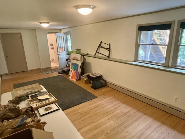 39 Mariner Cir, Trumbull, CT 06611 - workout area featuring a baseboard heating unit, wood finished floors, and plenty of natural light