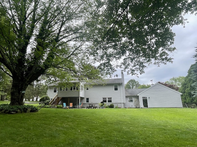 39 Mariner Cir, Trumbull, CT 06611 - rear view of property with stairs, a yard, and a chimney